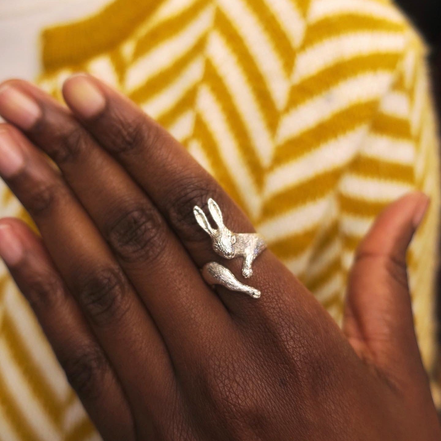 Rabbit ring in solid silver worn on the hand, poetic sculptural form.