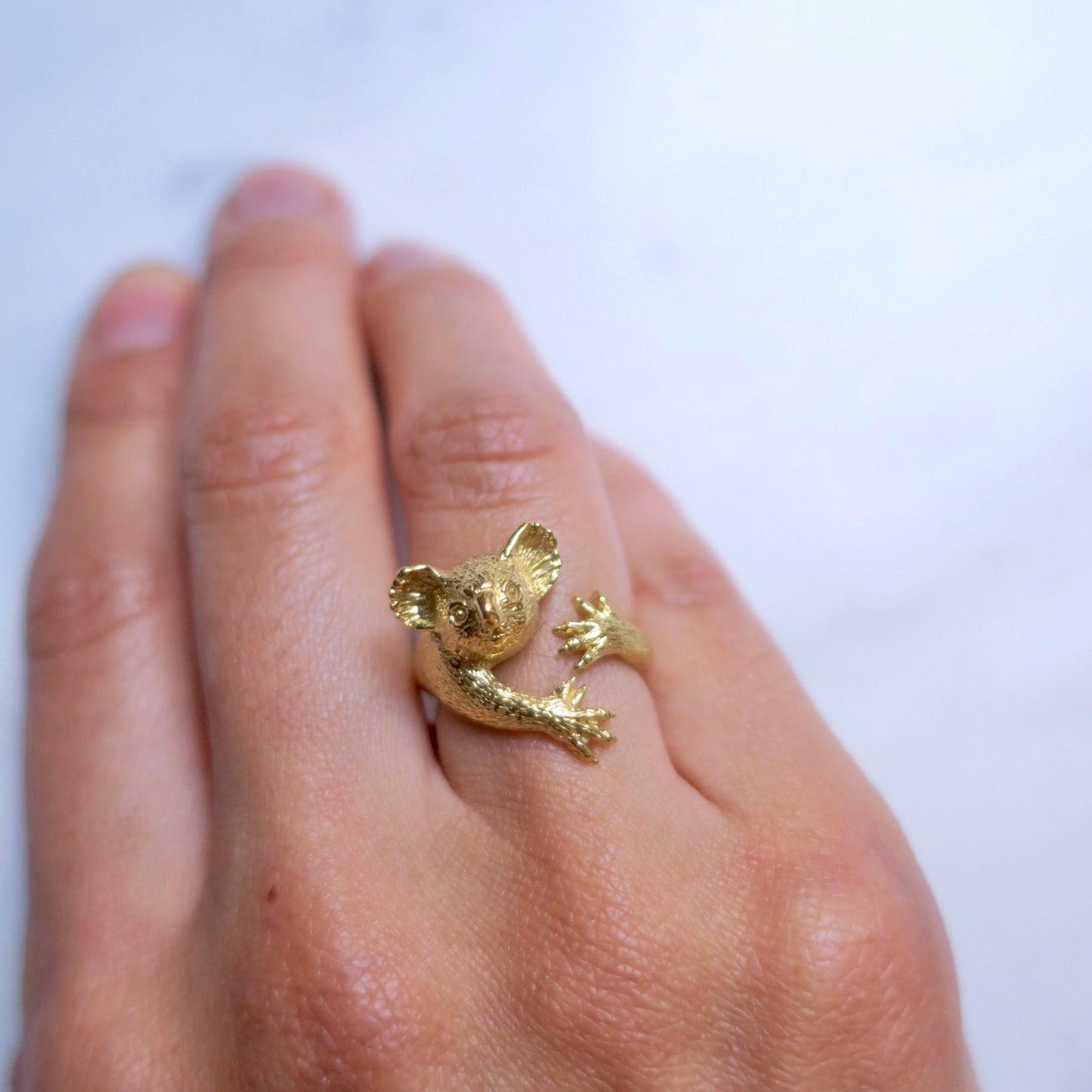 Gold koala ring worn on hand, elegant and playful — handmade animal ring by Japanese designer Fusako Koike Paris.