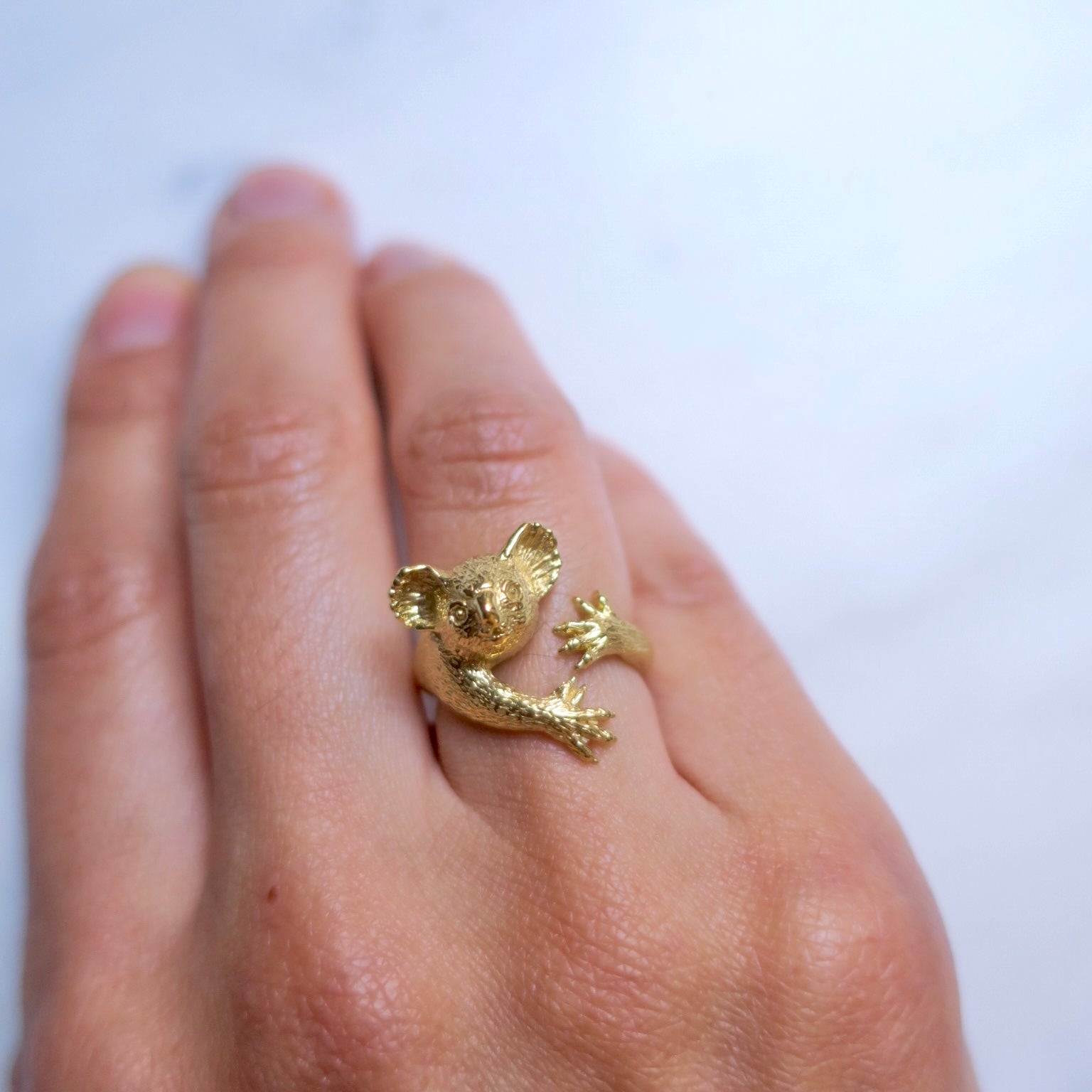 Gold koala ring worn on hand, elegant and playful — handmade animal ring by Japanese designer Fusako Koike Paris.