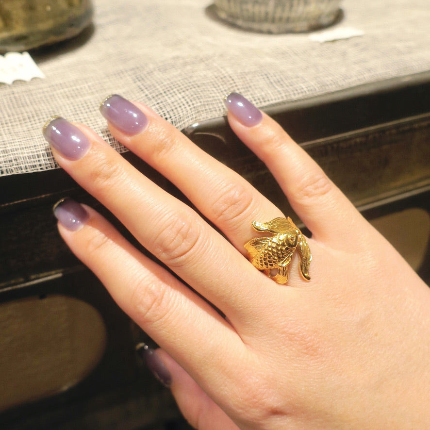 Gold-plated silver goldfish ring worn on a woman’s hand – handcrafted animal jewelry from Paris, detailed koi design symbolizing grace and vitality.