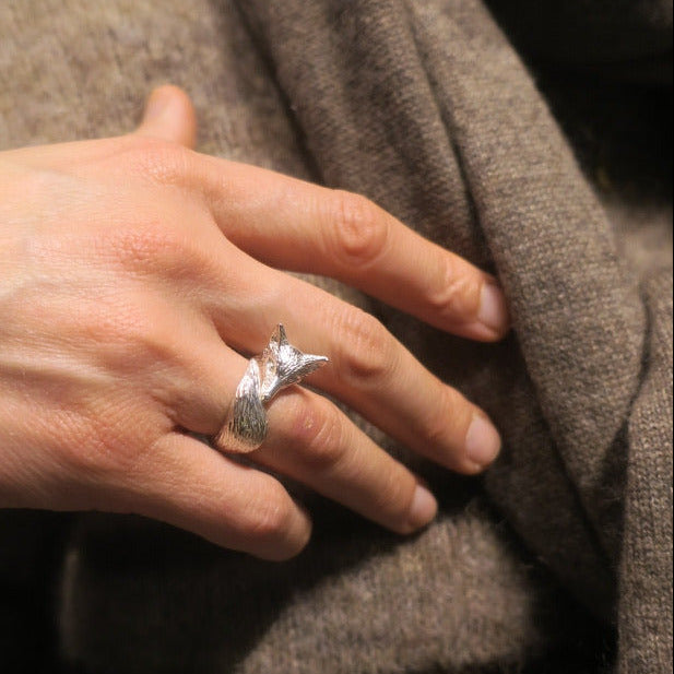 Fox ring worn on the hand — hand-sculpted silver jewelry that catches light and adds force to the fingers.