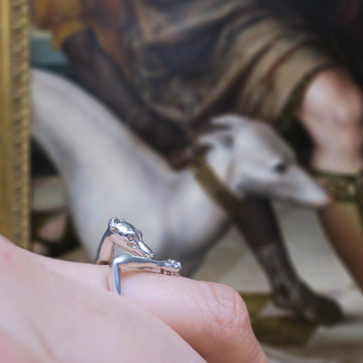 Italian Greyhound ring in solid sterling silver 925 worn on hand at the Louvre museum, side view showing elongated dog silhouette