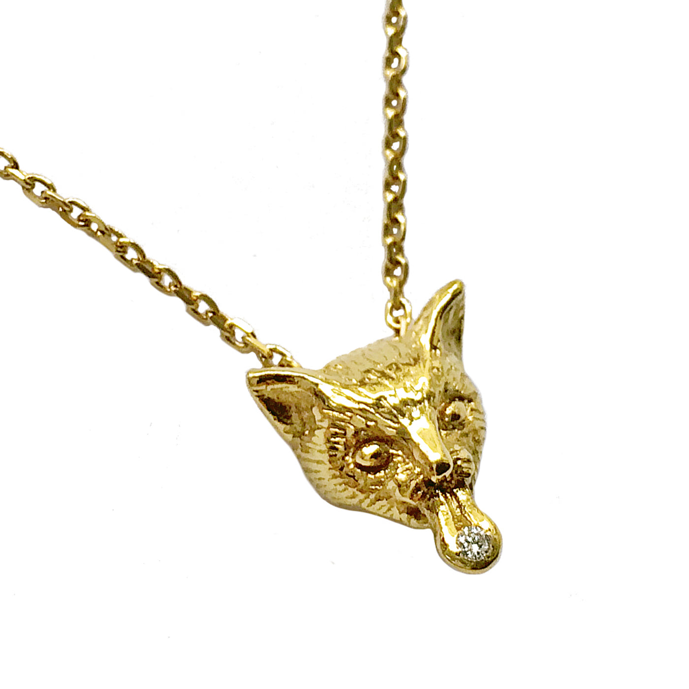 Hand-sculpted cat pendant in 18K gold-plated sterling silver, showing a playful tongue and a white sapphire like a small candy. Artisan animal jewelry crafted in Paris, detailed close-up.