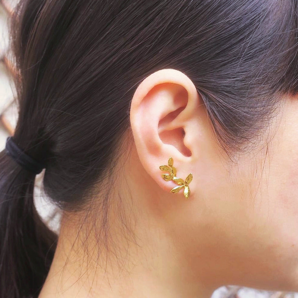 Laurel leaves earrings in gold plated silver worn on ear side view