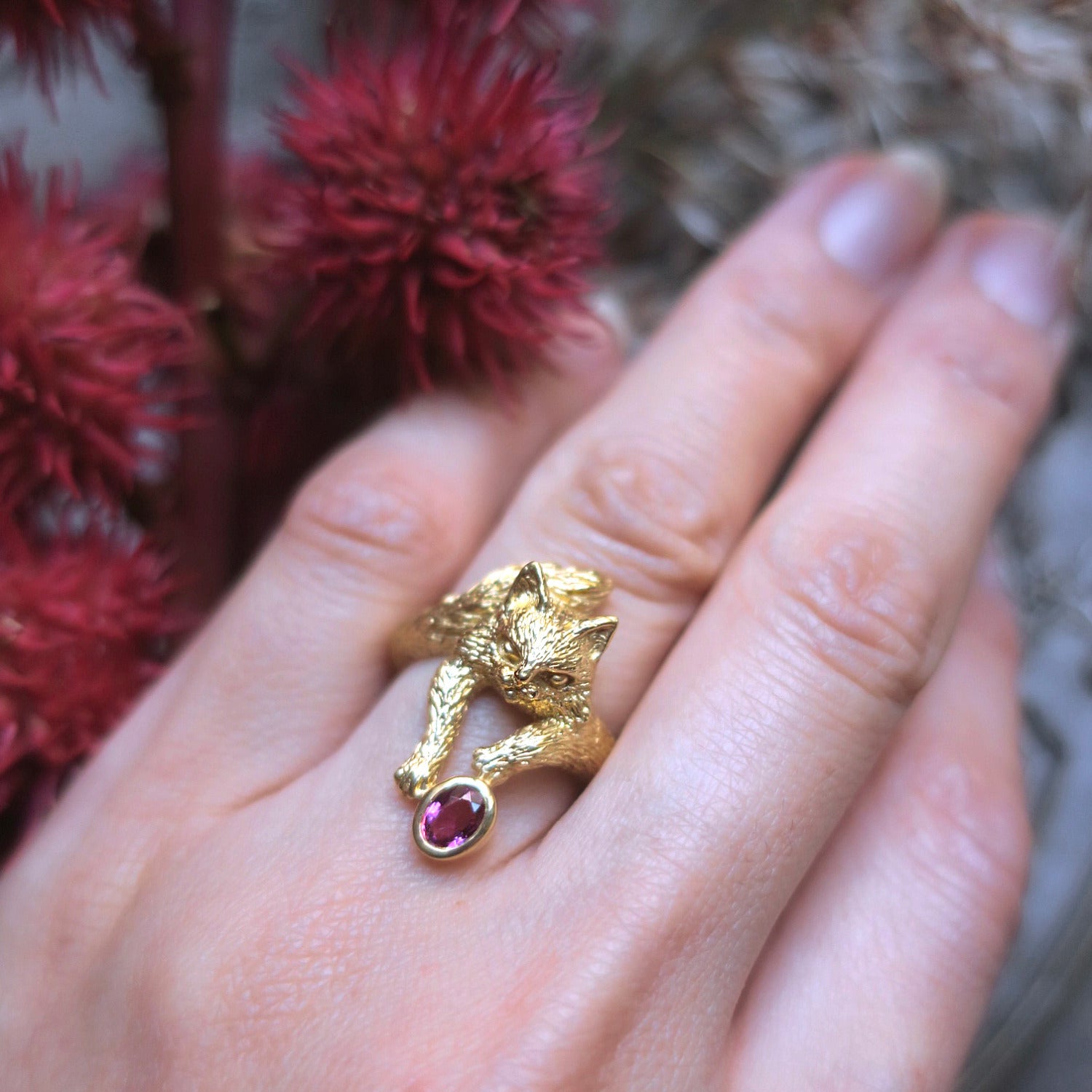 Hand wearing 18K gold-plated sterling silver Maine Coon cat ring with natural pink tourmaline
