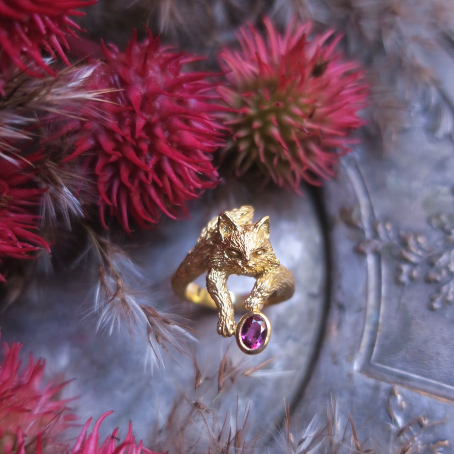 18K gold-plated sterling silver Maine Coon cat ring with natural pink tourmaline on antique tray with red flowers