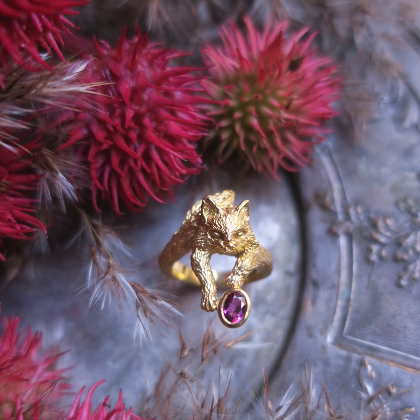 18K gold-plated sterling silver Maine Coon cat ring with natural pink tourmaline on antique tray with red flowers