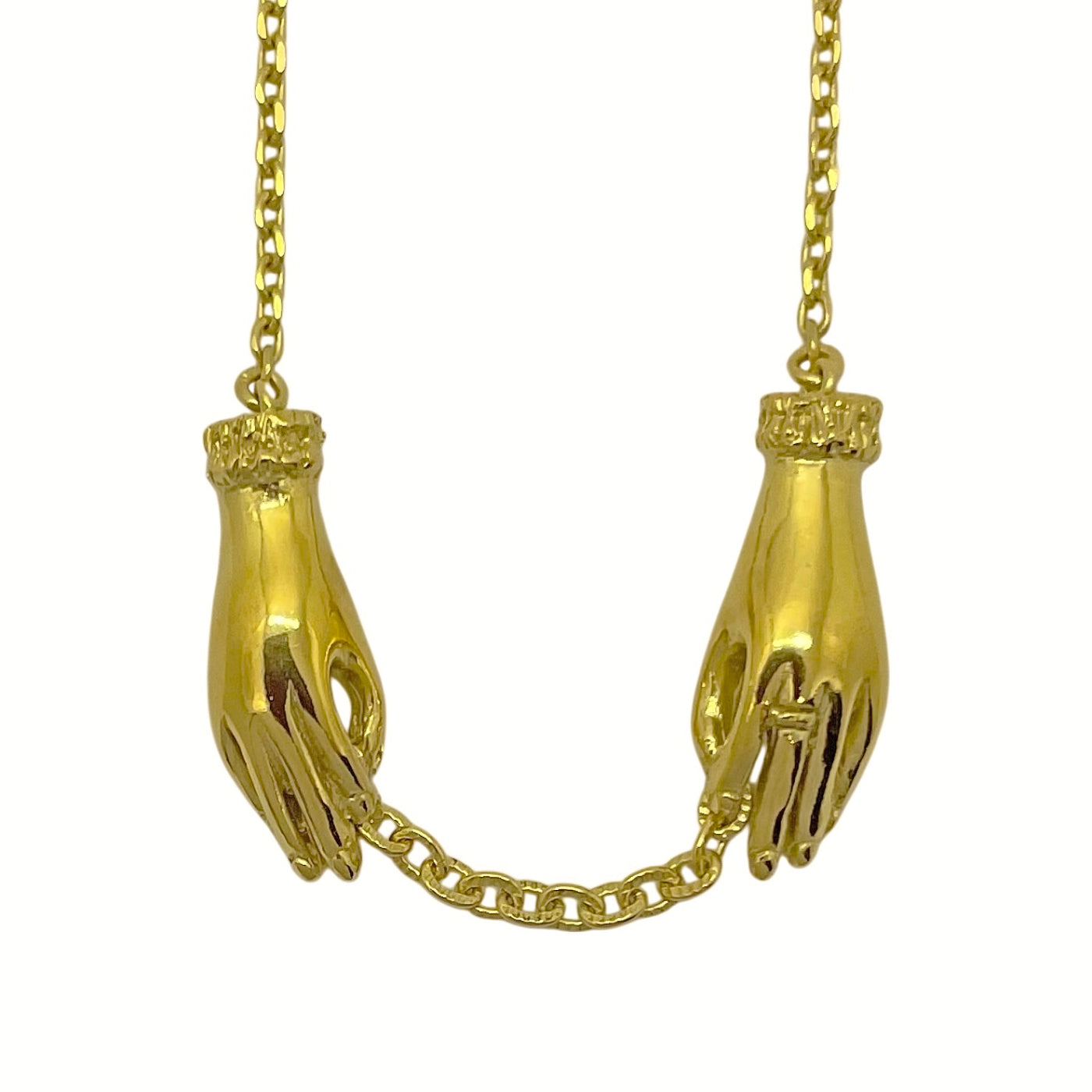 Gold-plated sterling silver hand necklace featuring two sculpted hands holding an antique-style chain. Artisan jewelry handmade in Paris.