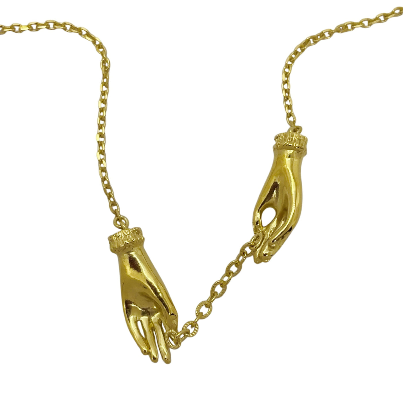 Side view of a gold-plated sterling silver hand necklace showing two sculpted hands connected by an antique-style chain. Handmade artisan jewelry from Paris.
