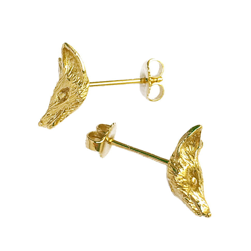 Side view of fox earrings showing detailed sculptural relief and stud post in gold-plated silver.