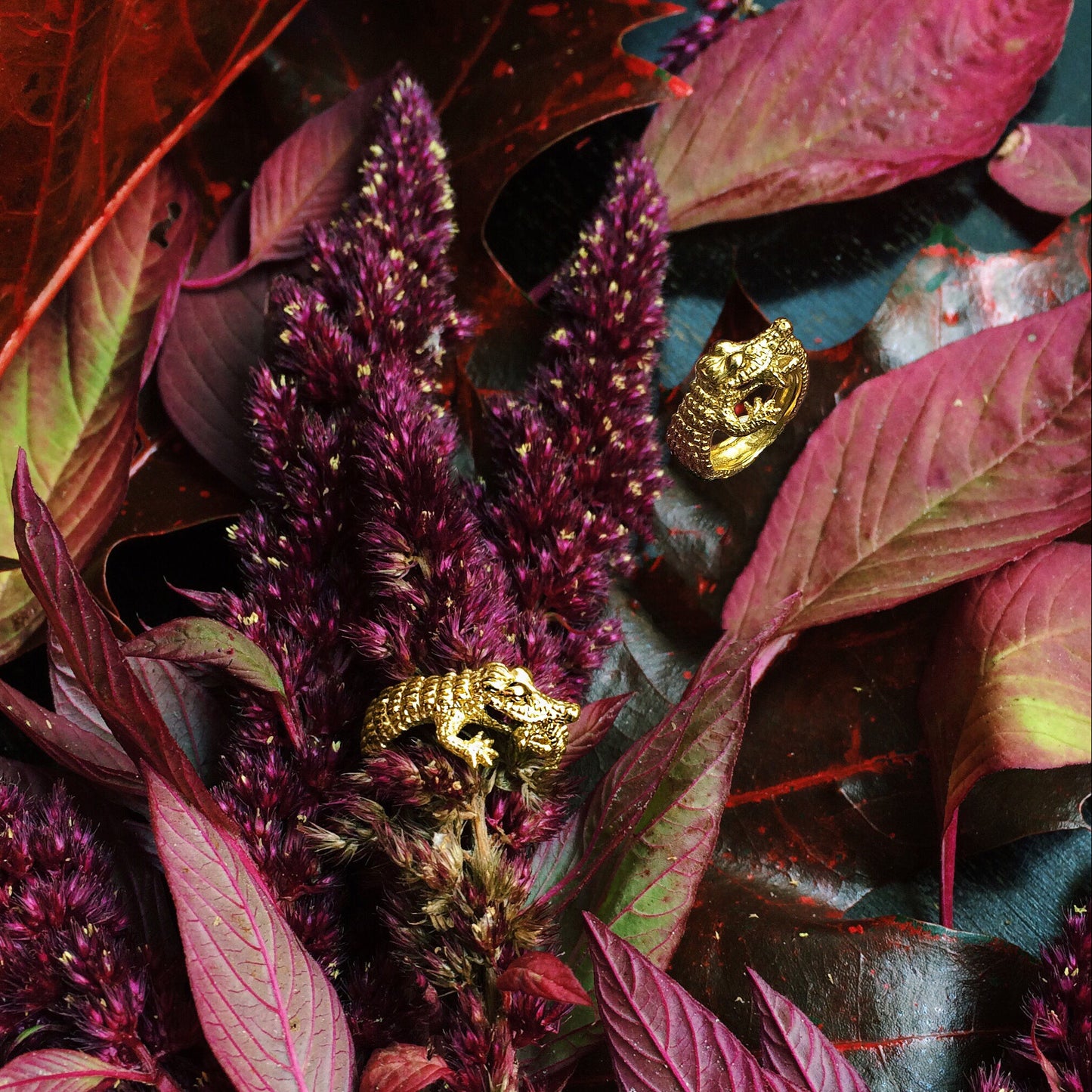 Crocodile ring in gold-plated silver displayed among red autumn leaves — poetic and nature-inspired handmade animal jewelry from Paris.