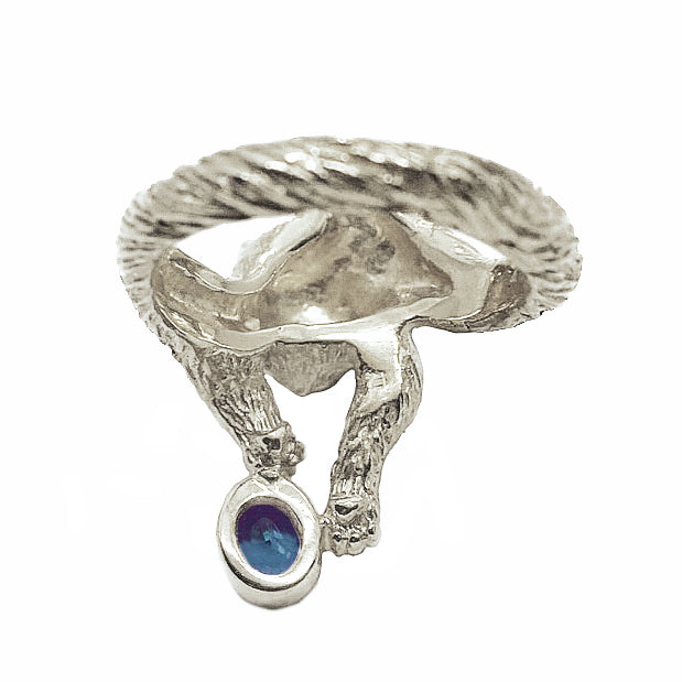 Maine Coon cat ring in sterling silver, featuring a long-haired cat holding a natural blue tourmaline with subtle green tones, sculptural animal jewelry.