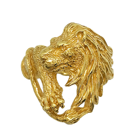 Hand-sculpted gold-plated lion ring showing detailed carving with a powerful paw and sharp claws, featuring a deeply textured mane on a white background.