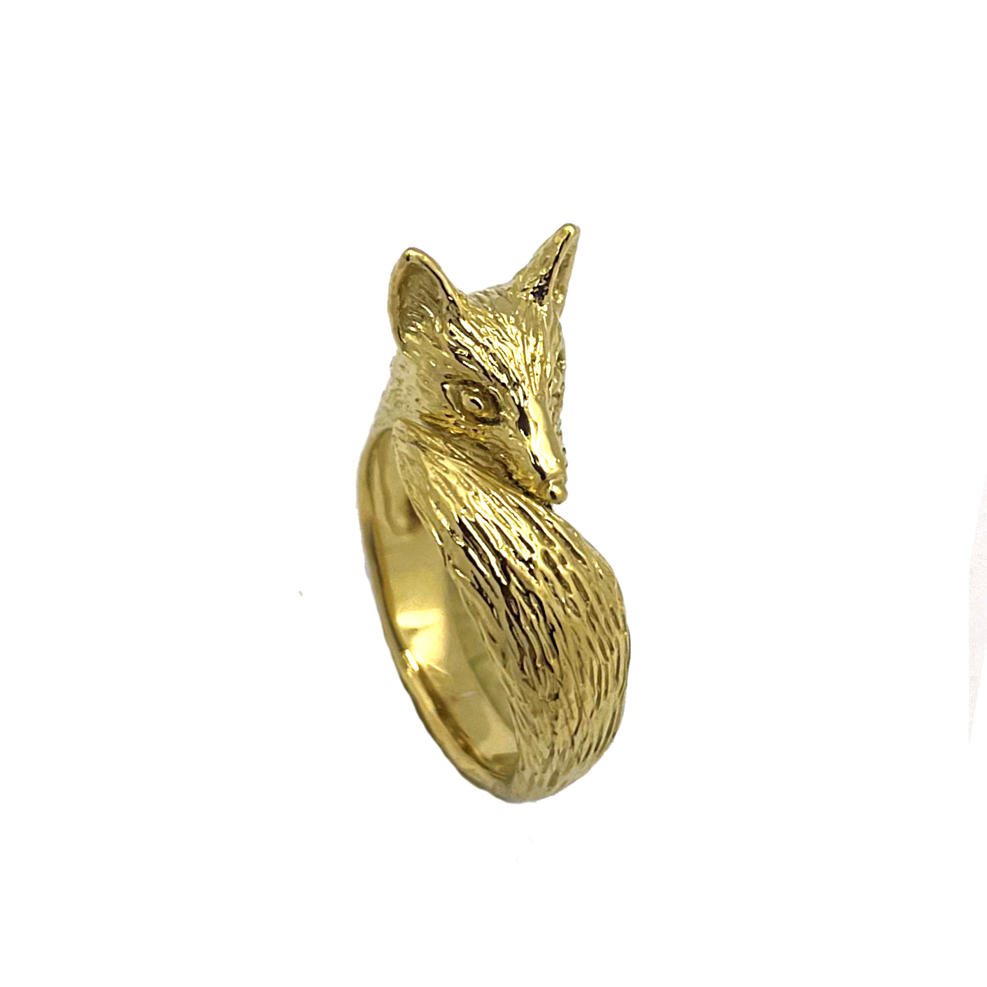 Side view of the gold fox pinky ring showing the sculptural silhouette, engraved fur detail