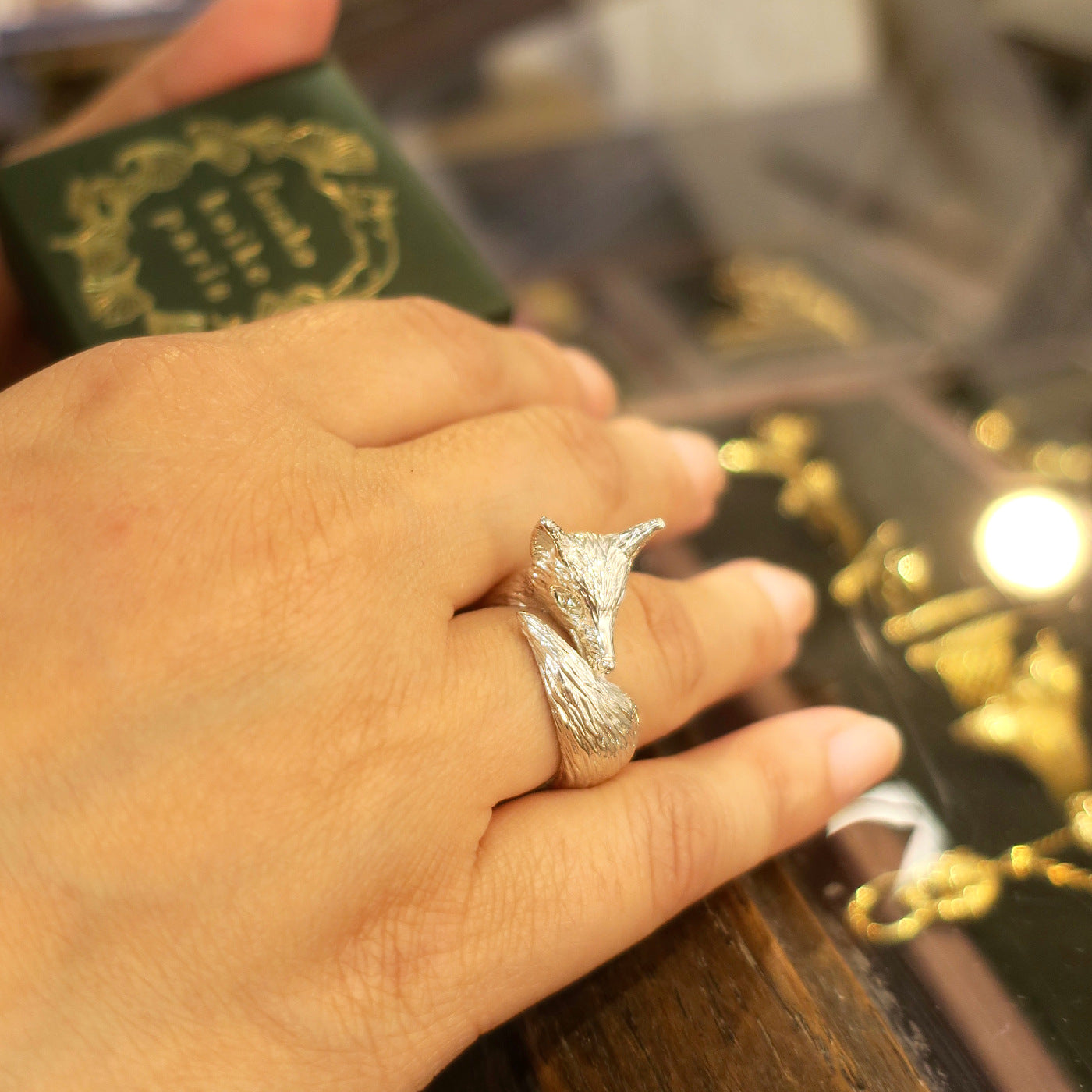 Fox ring in silver 925 worn on finger, realistic fur texture and curved tail, hand-sculpted animal ring