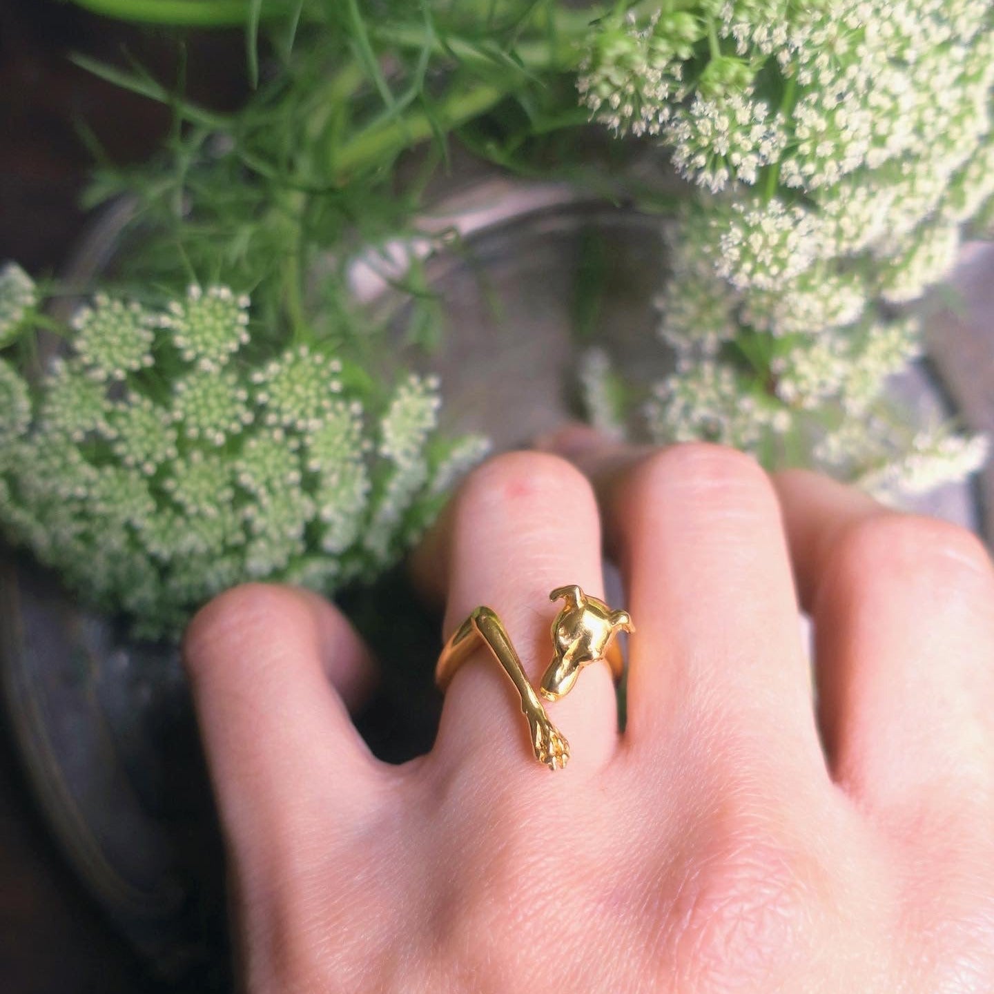 Italian Greyhound ring in 18K gold-plated silver 925 worn on finger, styled with white flowers, sculptural dog jewelry