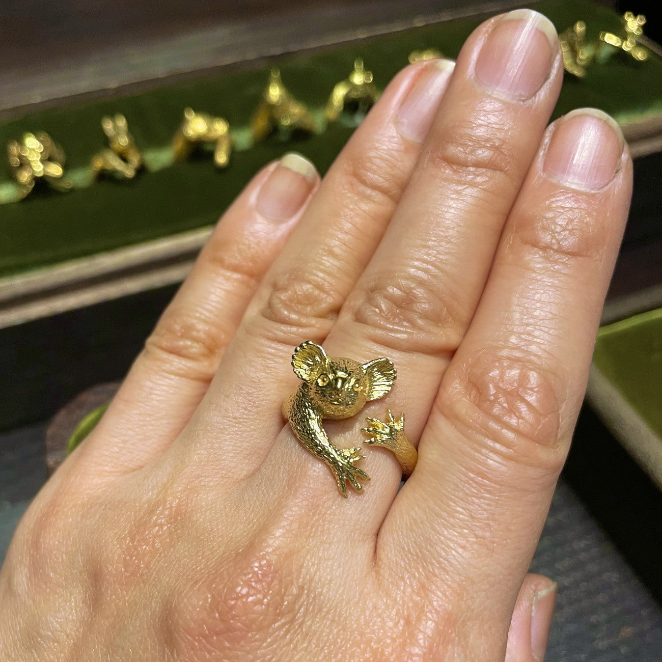 Koala ring in gold plated silver worn on finger gripping pose