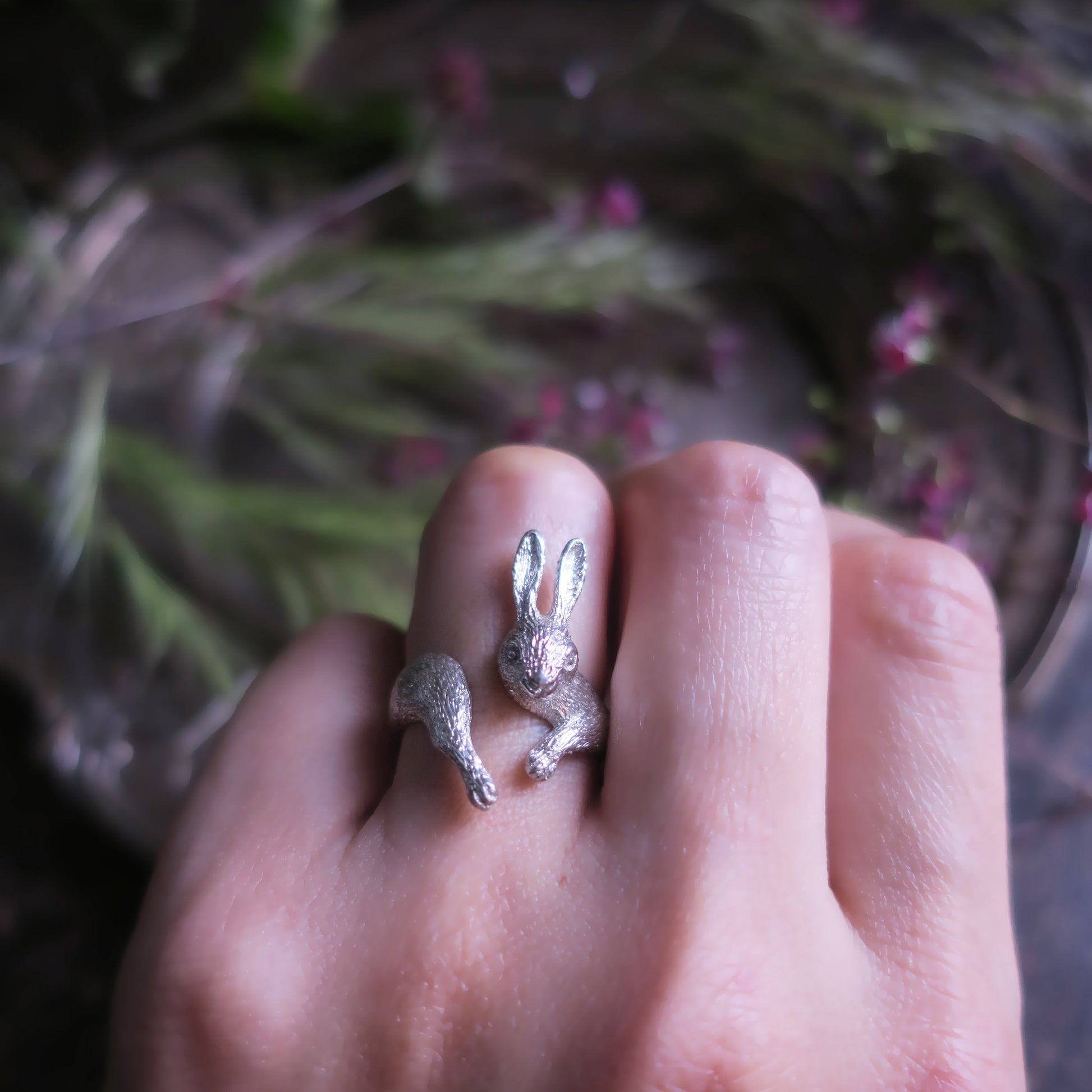 Rabbit ring in silver 925 worn on hand close-up, hand-sculpted animal jewelry
