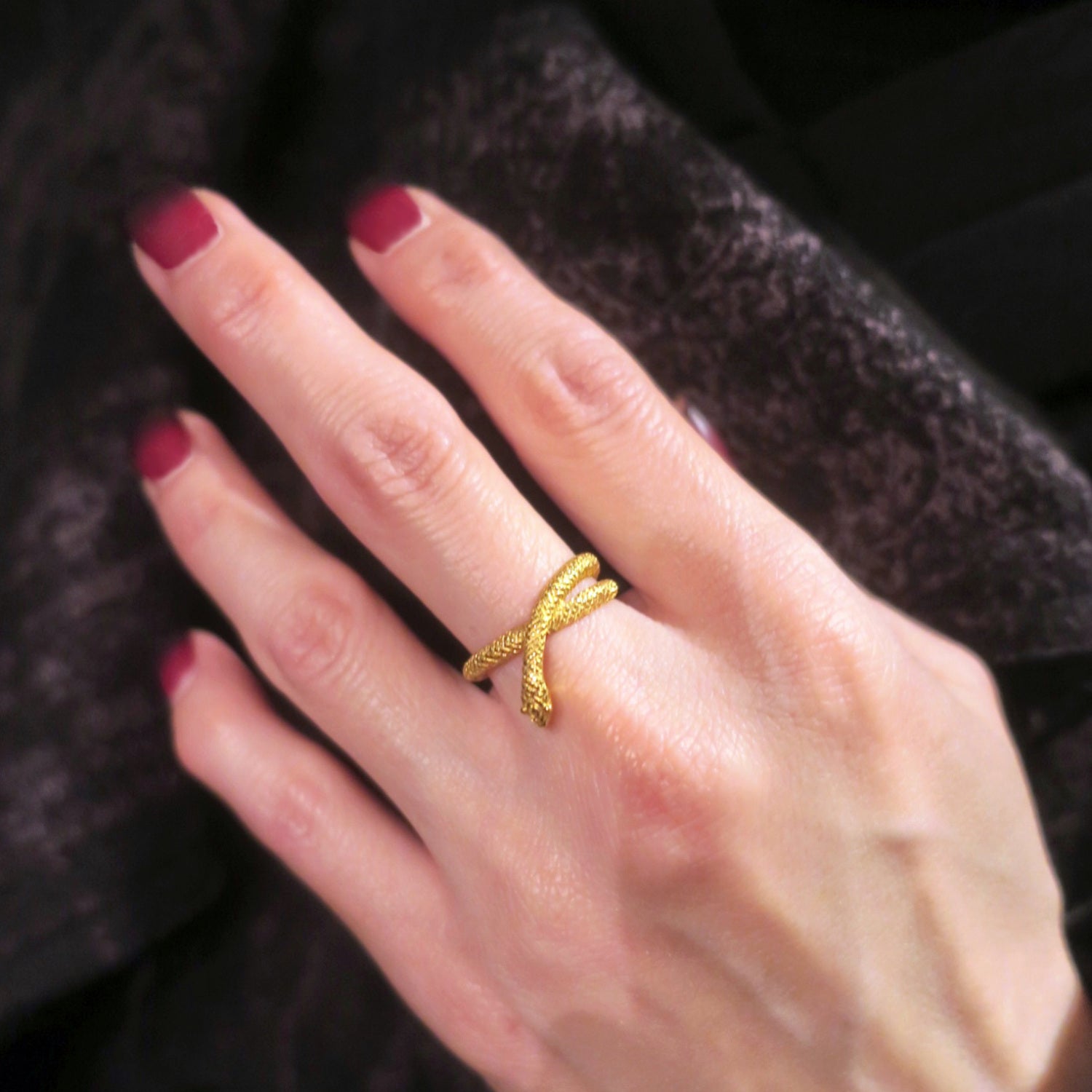 Snake ring in gold plated sterling silver worn on finger