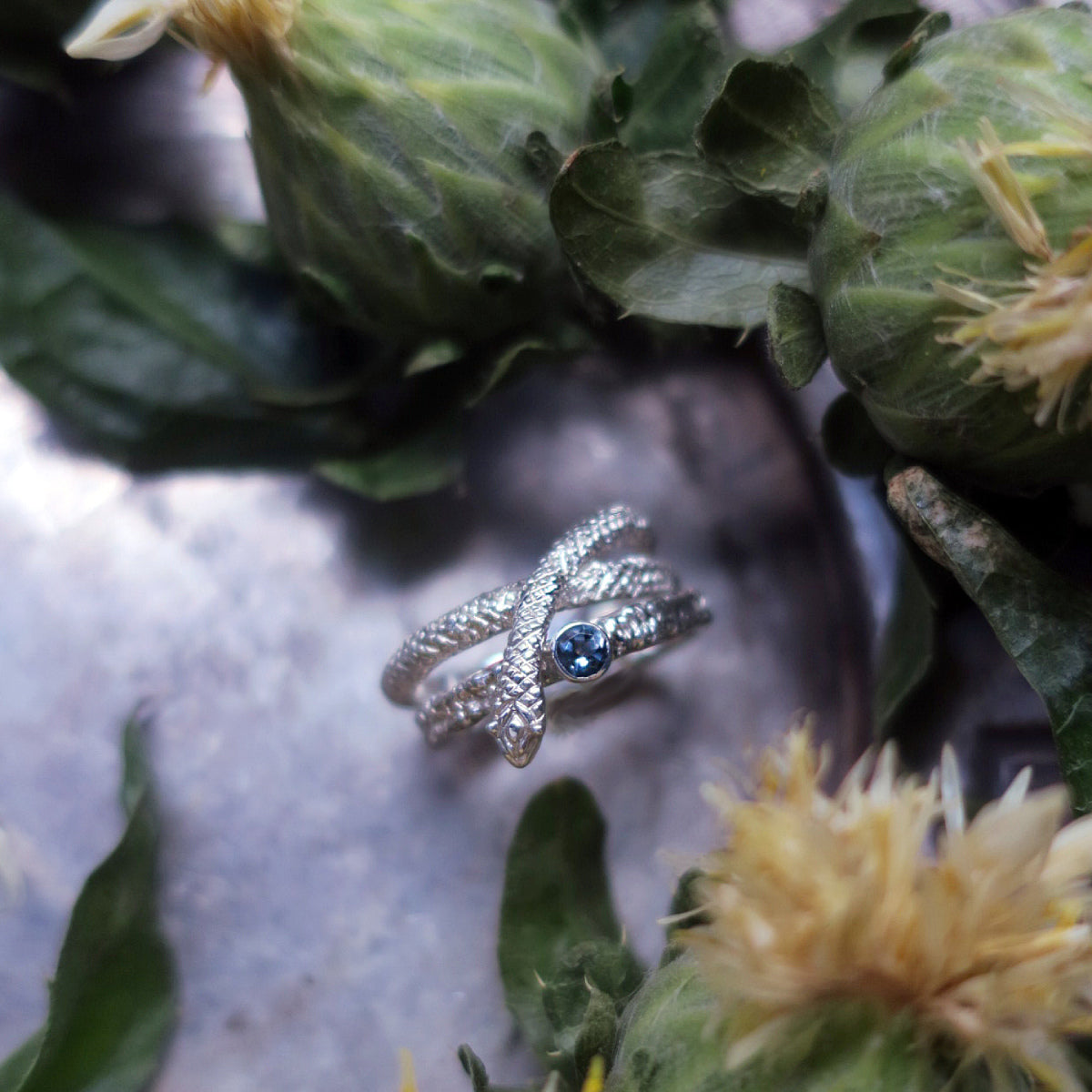 Snake ring in sterling silver stacked with blue topaz solitaire ring