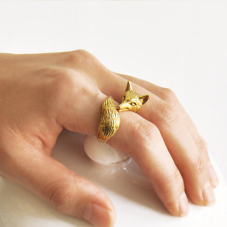 Fox ring worn on the hand — hand-sculpted jewelry that catches light and adds elegance to the fingers.